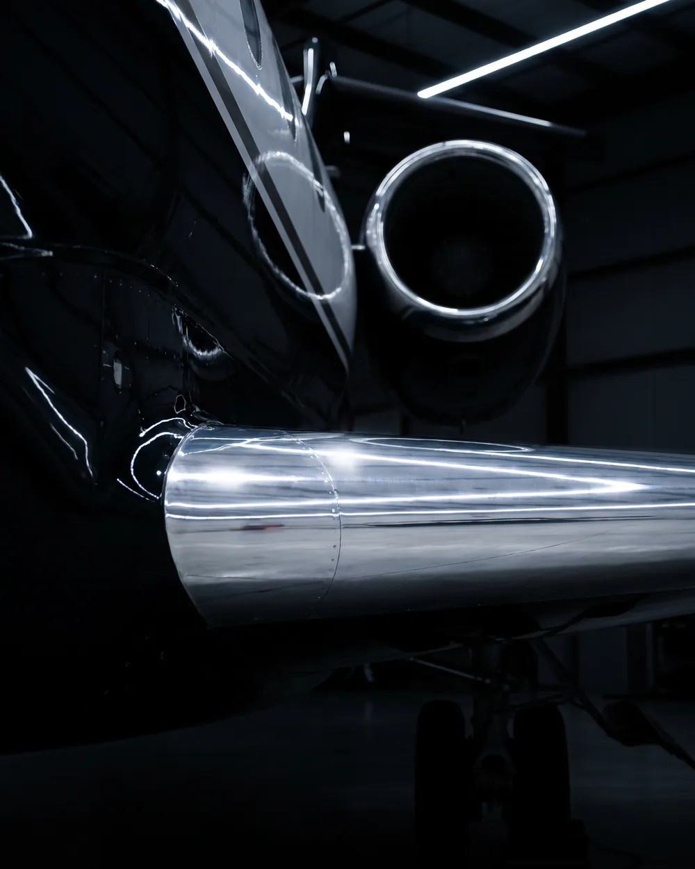 Mirror-polished aircraft brightwork reflecting the hangar lights
