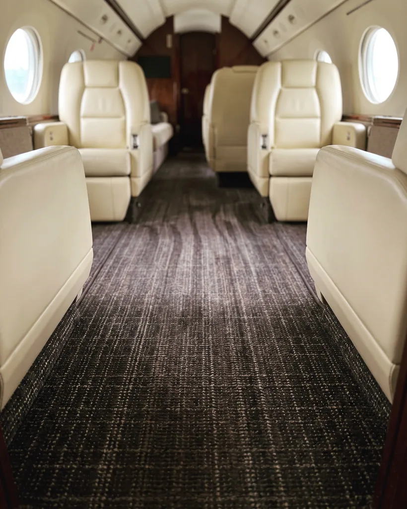 Freshly extracted carpet in a private jet cabin aisle